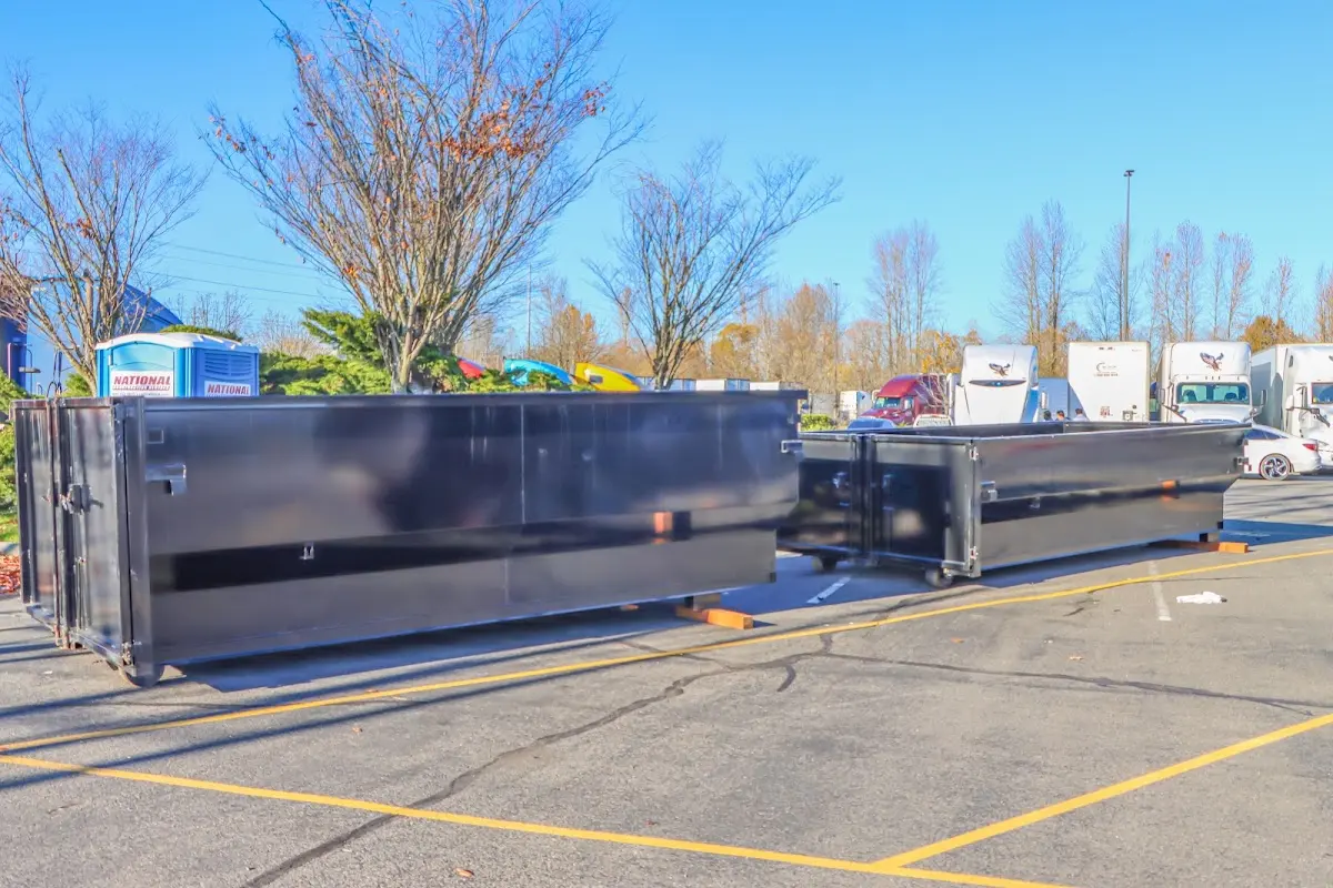 Professional dumpster rental service with roll-off container on residential driveway in Munhall